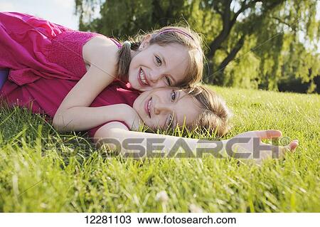 Sisters playing in a park; Toronto, Ontario, Canada View Large Photo Image Stock Image - Sisters playing in a park; Toronto, Ontario, Canada. Fotosearch