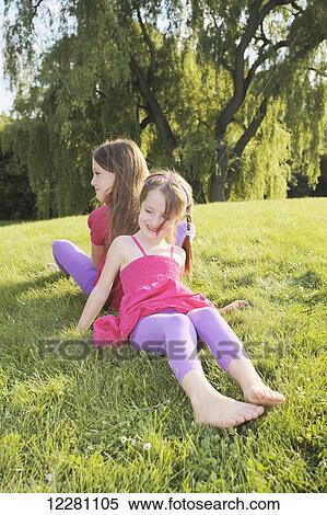 Sisters playing in a park; Toronto, Ontario, Canada View Large Photo Image Stock Photography - Sisters playing in a park; Toronto, Ontario, Canada. Fotosearch