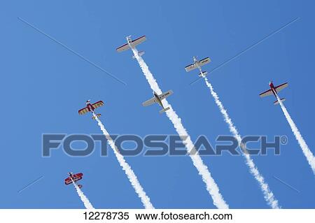 Stock Photography - Six aerobatic aircraft flying up in formation with smoke on; Rivadavia, Mendoza, Argentina. Fotosearch
