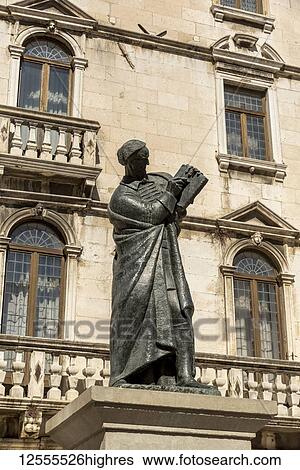 Stock Photograph - Statue of Marko Marulic, father of Croatian literature, by Ivan Mestrovic in front of the Milesi Palace in Fruit Square; Split, Croatia. Fotosearch