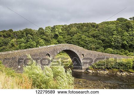 Stock Photo - Stone bridge crossing stream; Clachan-Seil, Scotland. Fotosearch