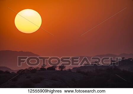 Stock Photograph - Sunset over the hills and mountains; Jawai, Rajasthan, India. Fotosearch