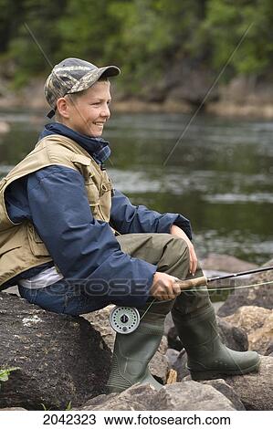 Stock Image - Teenage Boy Fishing On The Torrent River, Newfoundland & Labrador.. Fotosearch