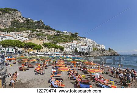 Picture - The beach view from the board walk in the town of Amalfi Italy, where tourists enjoy the sunlight and views of the Mediterranean Sea; Amalfi, Province of Salerno, Italy. Fotosearch