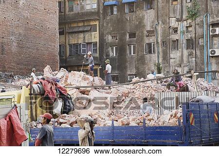 The site of a demolished building with workmen removing the rubble by hand; Yangon, Myanmar View Large Photo Image Stock Photograph - The site of a demolished building with workmen removing the rubble by hand; Yangon, Myanmar. Fotosearch