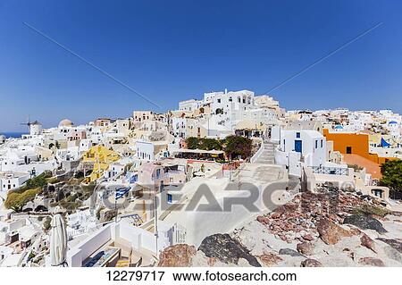 The town of Oia showing the traditional windmill and whitewashed village buildings; Satorini, Greek Islands, Greece View Large Photo Image Stock Photo - The town of Oia showing the traditional windmill and whitewashed village buildings; Satorini, Greek Islands, Greece. Fotosearch