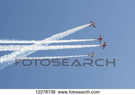 Three aerobatics aircraft are flying with smoke on while another is flying a loop around them; Rivadavia, Mendoza, Argentina View Large Photo Image Stock Photo - Three aerobatics aircraft are flying with smoke on while another is flying a loop around them; Rivadavia, Mendoza, Argentina. Fotosearch