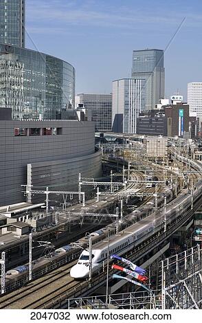 Tokyo International Forum, Tokyo Station In Background, Shinkansen Bullet Train Passing, Tokyo, Japan. View Large Photo Image Stock Image - Tokyo International Forum, Tokyo Station In Background, Shinkansen Bullet Train Passing, Tokyo, Japan.. Fotosearch