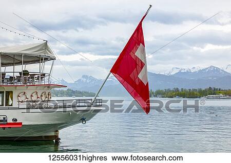 Stock Photograph - Tour boat with flag of Switzerland on Lake Lucerne; Lucerne, Lucerne, Switzerland. Fotosearch