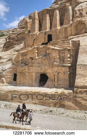 Stock Photograph - Tourists on horses, Obelisk Tomb (upper structure), Bab as-Sig Triclinium (lower Structure); Petra, Jordan. Fotosearch