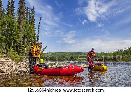 Two women packrafters getting ready to launch on the Charley River in summertime, YukonCharley Rivers National Preserve; Alaska, United States of America View Large Photo Image Stock Photograph - Two women packrafters getting ready to launch on the Charley River in summertime, YukonCharley Rivers National Preserve; Alaska, United States of America. Fotosearch