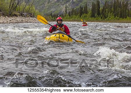 Two women packrafters negotiating a tributary of the Charley River in summertime, YukonCharley Rivers National Preserve; Alaska, United States of America View Large Photo Image Stock Photograph - Two women packrafters negotiating a tributary of the Charley River in summertime, YukonCharley Rivers National Preserve; Alaska, United States of America. Fotosearch