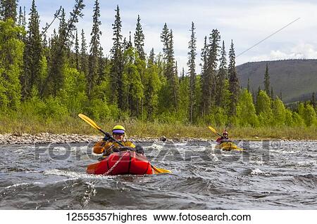 Two women packrafters negotiating a tributary of the Charley River in summertime, YukonCharley Rivers National Preserve; Alaska, United States of America View Large Photo Image Stock Photograph - Two women packrafters negotiating a tributary of the Charley River in summertime, YukonCharley Rivers National Preserve; Alaska, United States of America. Fotosearch