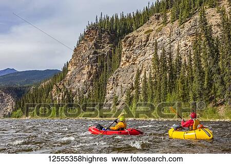 Two women packrafters negotiating a tributary of the Charley River in summertime, YukonCharley Rivers National Preserve; Alaska, United States of America View Large Photo Image Stock Photograph - Two women packrafters negotiating a tributary of the Charley River in summertime, YukonCharley Rivers National Preserve; Alaska, United States of America. Fotosearch