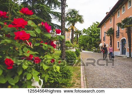 Two women walk down a pathway at Golf and Country Club Castello Di Spessa; Spessa, Province of Pavia, Lombardy, Italy View Large Photo Image Stock Photograph - Two women walk down a pathway at Golf and Country Club Castello Di Spessa; Spessa, Province of Pavia, Lombardy, Italy. Fotosearch