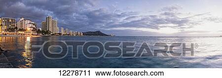 Stock Image - Waikiki Beach basking in the last moments of a days sunlight; Honolulu, Oahu, Hawaii, United States of America. Fotosearch