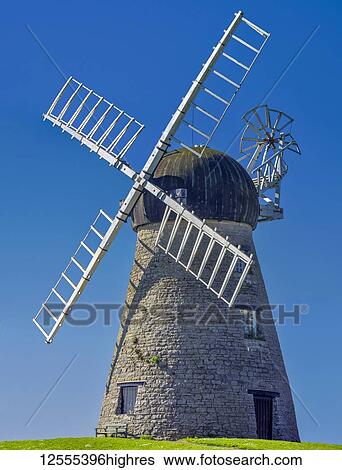 Windmill against a bright blue sky; Whitburn, Tyne and Wear, England View Large Photo Image Stock Photograph - Windmill against a bright blue sky; Whitburn, Tyne and Wear, England. Fotosearch