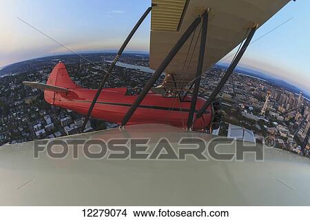 Picture - Wingtip view of Waco UPF-7 biplane; Puget Sound, Washington, United States of America. Fotosearch