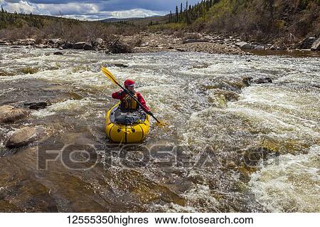 Woman packrafter negotiating a technical rapid on the tributary of the Charley River with aufeis in summertime, YukonCharley Rivers National Preserve; Alaska, United States of America View Large Photo Image Stock Photograph - Woman packrafter negotiating a technical rapid on the tributary of the Charley River with aufeis in summertime, YukonCharley Rivers National Preserve; Alaska, United States of America. Fotosearch