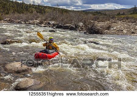 Woman packrafter negotiating a technical rapid on the tributary of the Charley River with aufeis in summertime, YukonCharley Rivers National Preserve; Alaska, United States of America View Large Photo Image Stock Photograph - Woman packrafter negotiating a technical rapid on the tributary of the Charley River with aufeis in summertime, YukonCharley Rivers National Preserve; Alaska, United States of America. Fotosearch