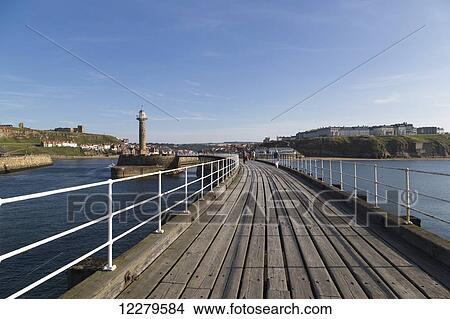 Wooden boardwalk crossing waterfront; Whitby, North Yorkshire, England View Large Photo Image Picture - Wooden boardwalk crossing waterfront; Whitby, North Yorkshire, England. Fotosearch