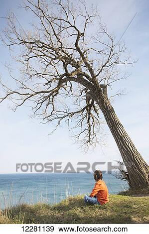 Stock Photo - Young boy looking over lake at Scarborough Bluffs; Toronto, Ontario, Canada. Fotosearch
