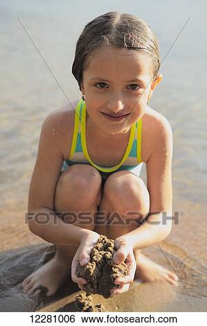 Young girl at the beach playing in the sand; Ontario, Canada View Large Photo Image Stock Photograph - Young girl at the beach playing in the sand; Ontario, Canada. Fotosearch
