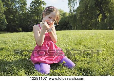 Young girl collecting wildflowers in a park; Toronto, Ontario, Canada View Large Photo Image Stock Photo - Young girl collecting wildflowers in a park; Toronto, Ontario, Canada. Fotosearch