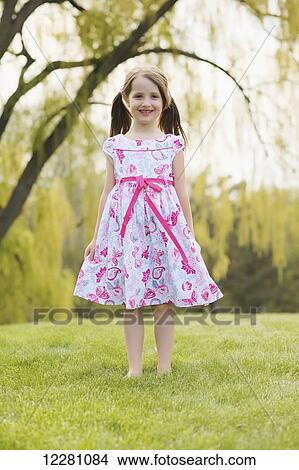 Young girl modeling a floral dress; Toronto, Ontario, Canada View Large Photo Image Picture - Young girl modeling a floral dress; Toronto, Ontario, Canada. Fotosearch