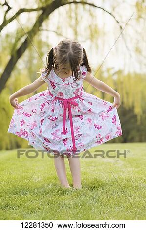 Stock Image - Young girl modeling a floral dress; Toronto, Ontario, Canada. Fotosearch