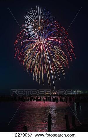 Stock Photo - A fireworks display celebrates July 4th; Astoria, Oregon, United States of America. Fotosearch