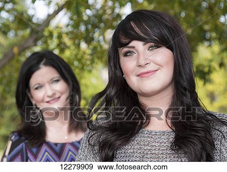 A mother standing behind her daughter and supporting her in her goals and dreams; St. Albert, Alberta, Canada View Large Photo Image Stock Photo - A mother standing behind her daughter and supporting her in her goals and dreams; St. Albert, Alberta, Canada. Fotosearch