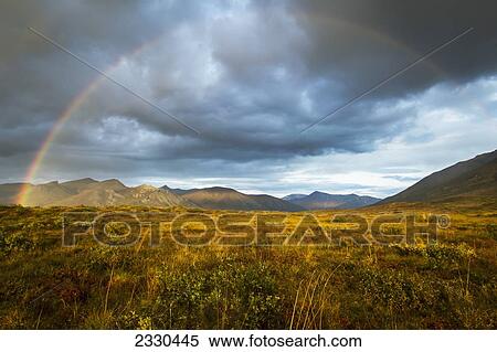 Stock Photography - A Rainbow In The Sky Over Brooks Range, Gates Of The Arctic National Park In Northwestern Alaska; Alaska, United States Of America. Fotosearch
