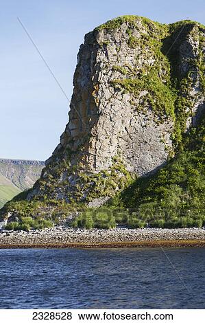 A Rock Cliff Along The Coastline; False Pass, Alaska, United States Of America View Large Photo Image Stock Photo - A Rock Cliff Along The Coastline; False Pass, Alaska, United States Of America. Fotosearch