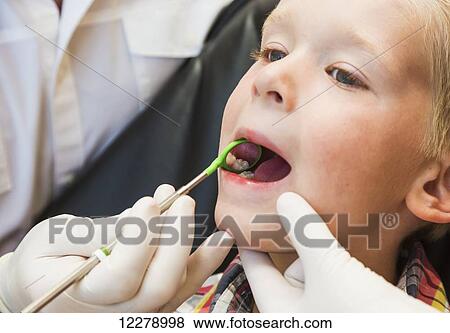 A young boy at a dental examination; Edmonton, Alberta, Canada View Large Photo Image Stock Photo - A young boy at a dental examination; Edmonton, Alberta, Canada. Fotosearch