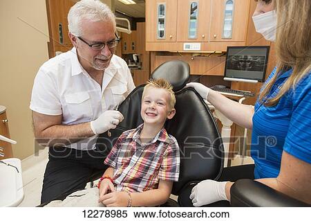 A young boy at a dental examination; Edmonton, Alberta, Canada View Large Photo Image Stock Photography - A young boy at a dental examination; Edmonton, Alberta, Canada. Fotosearch