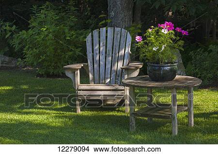 Picture - Adirondack chair and flower pot; Knowlton, Quebec, Canada. Fotosearch