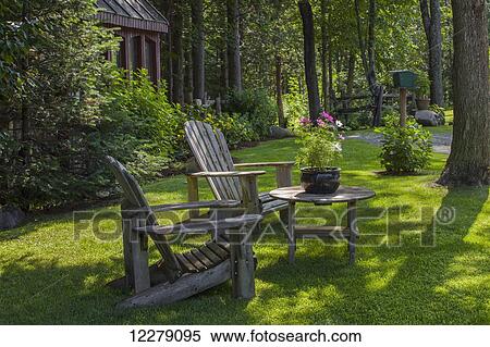 Adirondack chairs and flower pot; Knowlton, Quebec, Canada View Large Photo Image Stock Photography - Adirondack chairs and flower pot; Knowlton, Quebec, Canada. Fotosearch