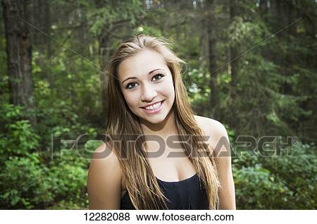 Beautiful teenage girl posing for a picture while walking in a park; Edmonton, Alberta, Canada View Large Photo Image Stock Photo - Beautiful teenage girl posing for a picture while walking in a park; Edmonton, Alberta, Canada. Fotosearch