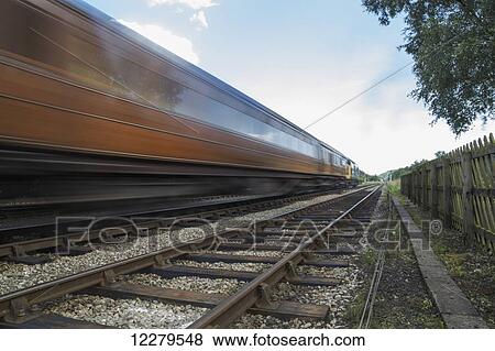 Blur of a train speeding along the tracks; Ainthorpe, North Yorkshire, England View Large Photo Image Stock Photo - Blur of a train speeding along the tracks; Ainthorpe, North Yorkshire, England. Fotosearch