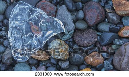 Bright Coloured Rocks And Chunk Of Ice Along The Southern Shore Of Iceland; Iceland View Large Photo Image Stock Image - Bright Coloured Rocks And Chunk Of Ice Along The Southern Shore Of Iceland; Iceland. Fotosearch