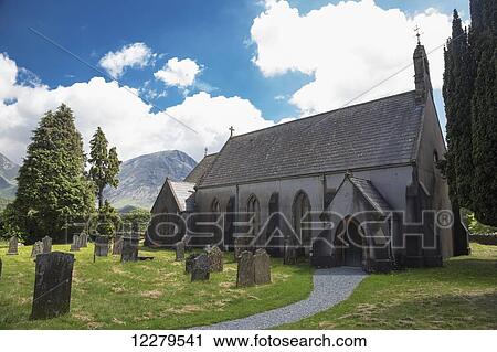 Stock Image - Church and old cemetery; Cumbria, England. Fotosearch