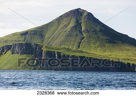Stock Photo - Cliff And Mountain Along The Coastline; False Pass, Alaska, United States Of America. Fotosearch