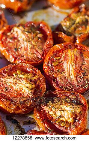 Close up of sun dried tomatoes on baking sheet with herbs; Calgary, Alberta, Canada View Large Photo Image Stock Photo - Close up of sun dried tomatoes on baking sheet with herbs; Calgary, Alberta, Canada. Fotosearch