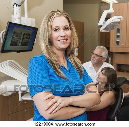 Dental assistant posing during dental consultation with patient; Edmonton, Alberta, Canada View Large Photo Image Picture - Dental assistant posing during dental consultation with patient; Edmonton, Alberta, Canada. Fotosearch