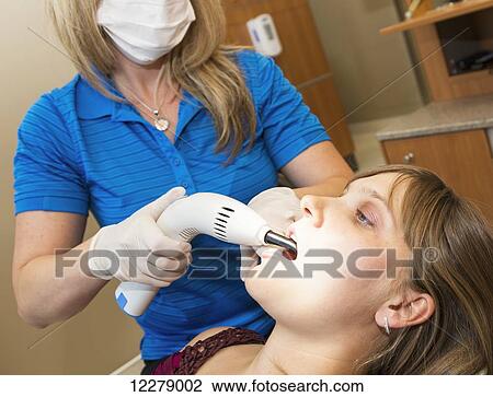 Dental assistant using light curing machine on composite filling; Edmonton, Alberta, Canada View Large Photo Image Stock Image - Dental assistant using light curing machine on composite filling; Edmonton, Alberta, Canada. Fotosearch
