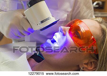 Stock Photography - Dentist using fluorescence visualization to check for oral diseases; Edmonton, Alberta, Canada. Fotosearch