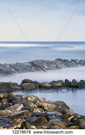 Driftwood and rocks along the coast of Lydgate Beach Park; Lydgate, Kauai, Hawaii, United States of America View Large Photo Image Stock Photo - Driftwood and rocks along the coast of Lydgate Beach Park; Lydgate, Kauai, Hawaii, United States of America. Fotosearch