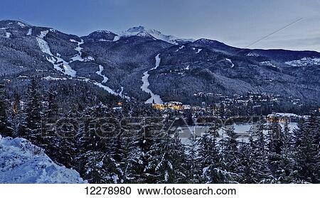 Stock Image - Dusk settles on Whistler Mountain in the creekside of Whistler; Whistler, British Columbia, Canada. Fotosearch