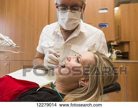 Picture - Female patient at dental appointment; Edmonton, Alberta, Canada. Fotosearch